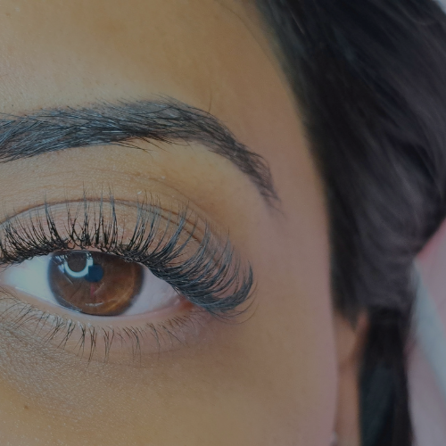 Zen Luxe Med Spa Aesthetic Services with Injector Resha A close up of a woman's eye with long lashes and brows