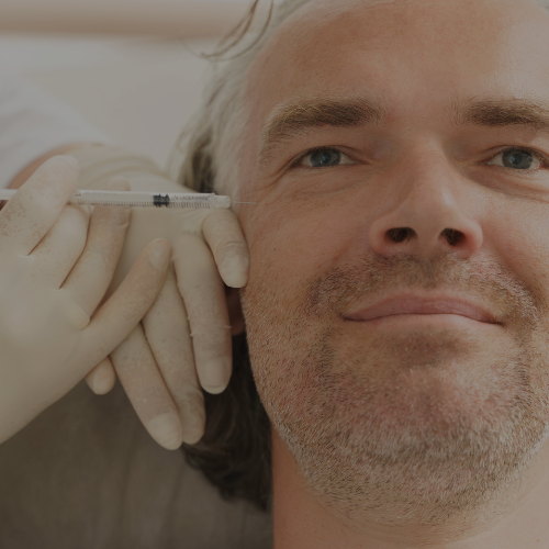 Zen Luxe Med Spa Aesthetic Services with Injector Resha A man is getting a syringe injected into his face. A solutions for men.