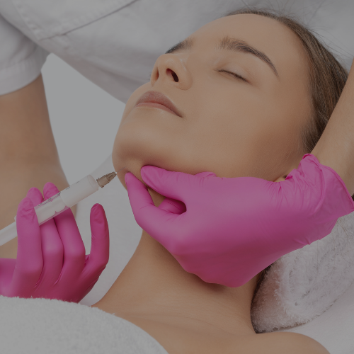 Zen Luxe Med Spa Aesthetic Services with Injector Resha treating A woman by giving a Kybella facial injection .